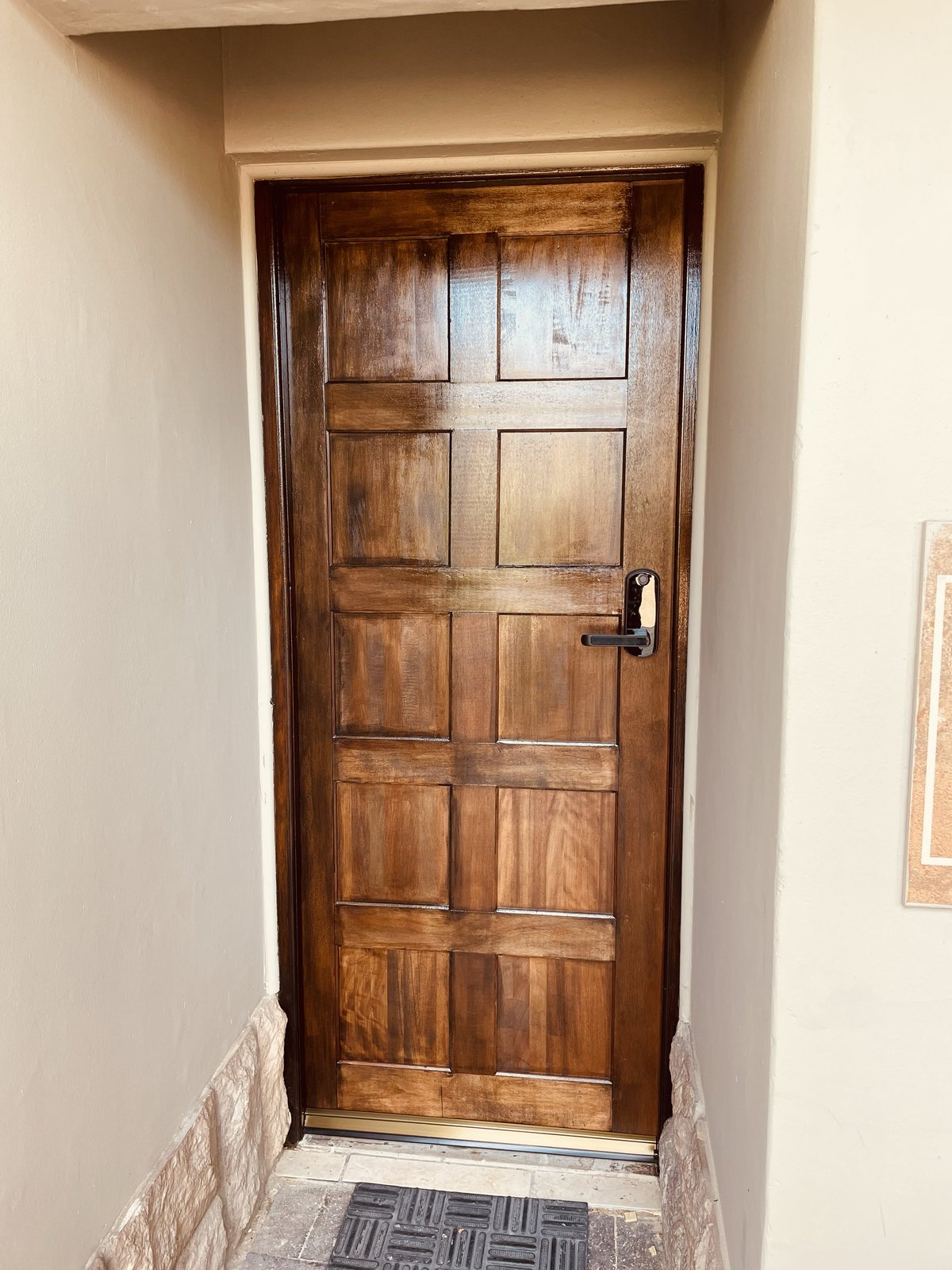 Ebony hard wood door installation with electronic integrated lock handle