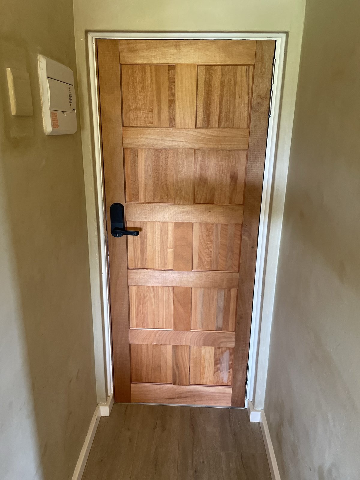 Ebony hard wood door installation with electronic integrated lock handle